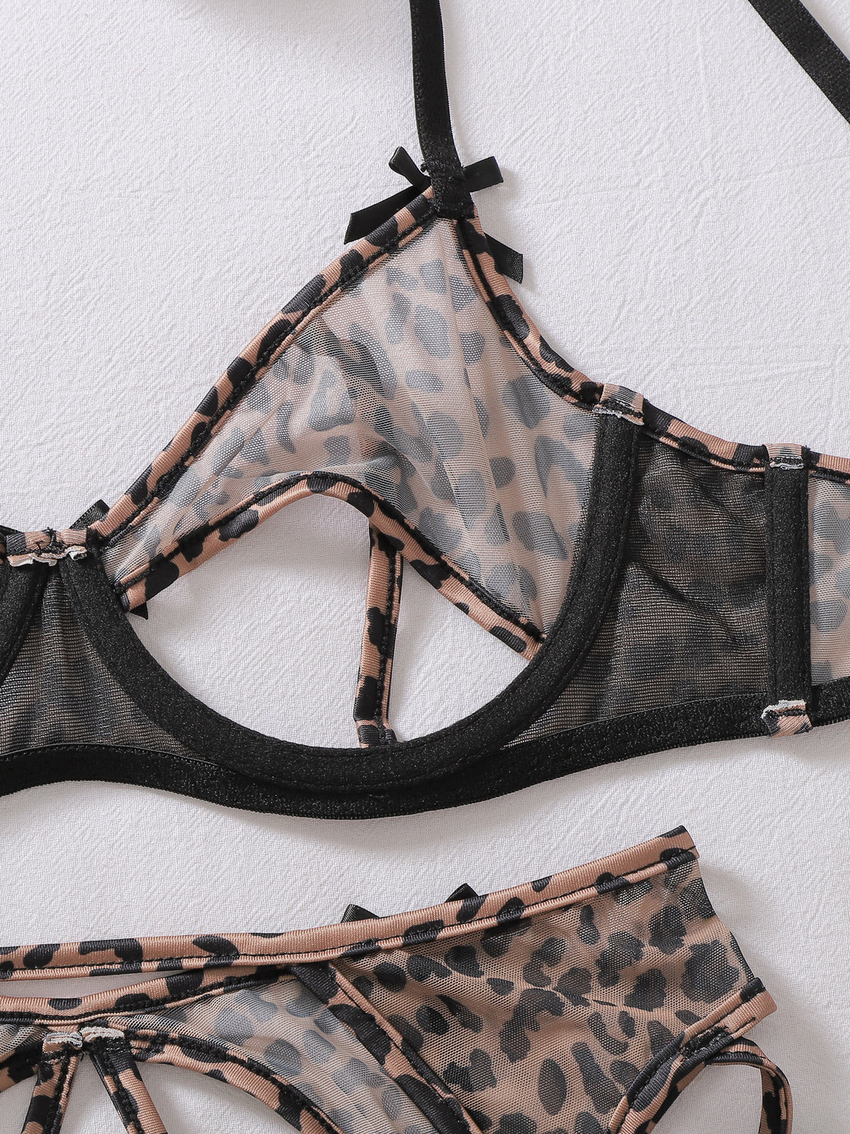 Wild leopard-print lingerie and stocking set featuring sexy bow accents and cut-out details.