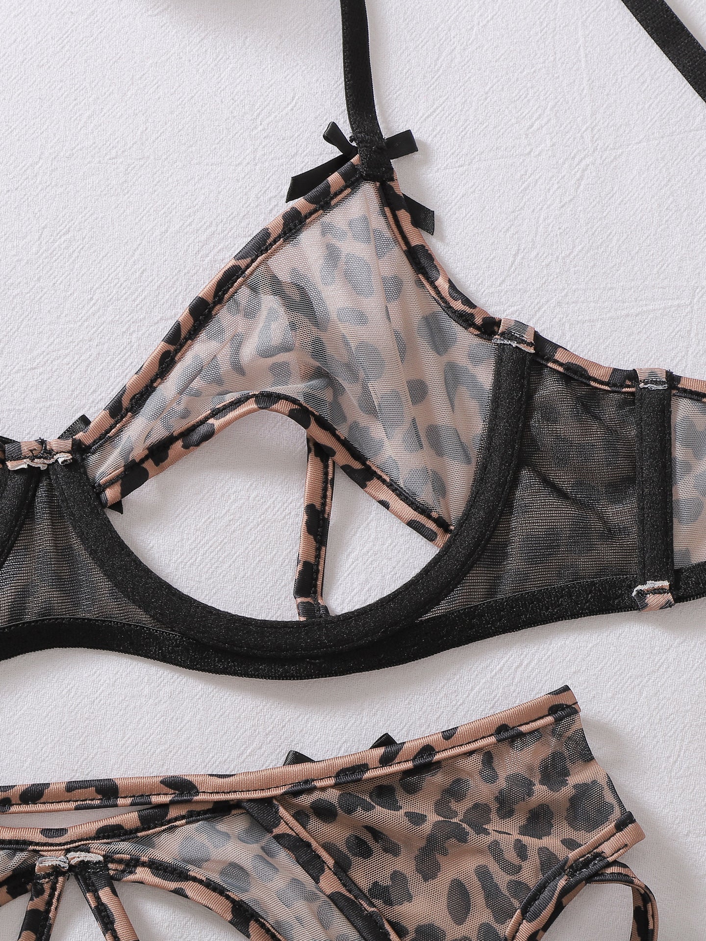 Wild leopard-print lingerie and stocking set featuring sexy bow accents and cut-out details.